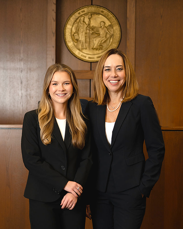 Shelby Thomas and Carolyn Peacock standing in a court room